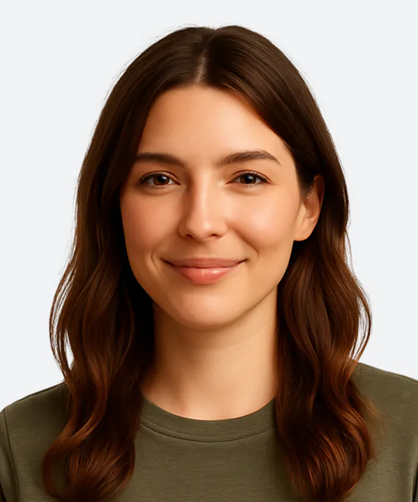 Portrait of a woman with long brown hair wearing an olive green shirt against a white background.