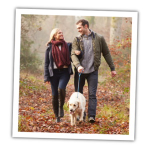 Couple walking dog.
