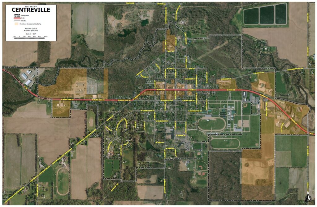 A high-resolution aerial satellite map of the Village of Centreville. The map identifies village limits with a dashed line, highlights the M-86 highway corridor in red, and shades the Downtown Development Authority (DDA) districts in tan.