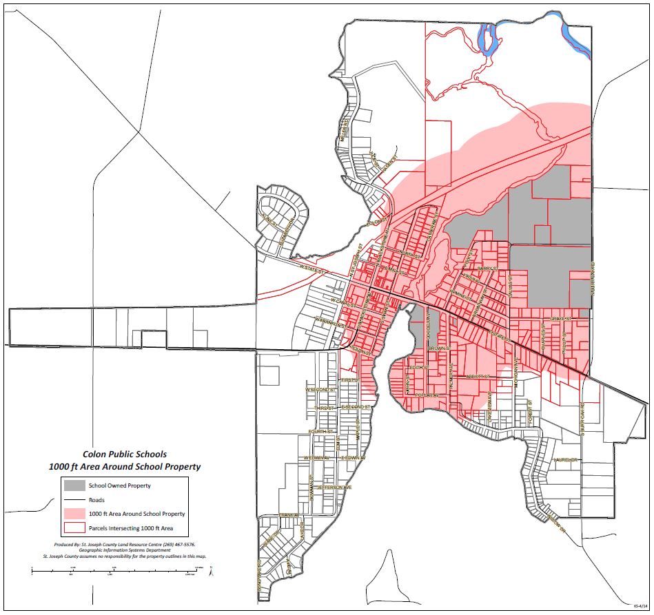 Map of Colon, Michigan, showing Colon Public Schools owned property in gray and a red-shaded 1,000-foot buffer zone surrounding the school grounds. The shaded area covers a significant portion of the residential village grid and intersects various property parcels.