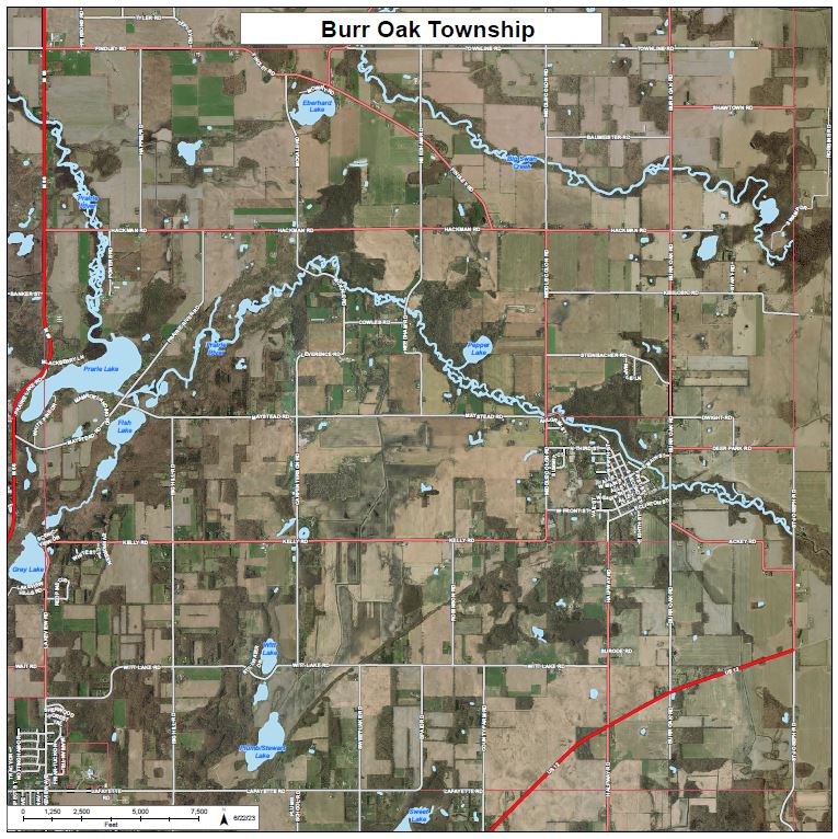 An aerial satellite map of Burr Oak Township showing a rural landscape of farmland, forests, and lakes. Key features include the Prairie River winding through the center, several named lakes like Eberhard and Prairie Lake, and the US-12 highway in the southeast corner.