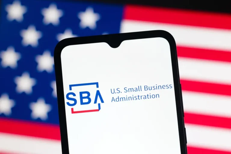 Smartphone displaying the SBA logo and "U.S. Small Business Administration" text against an American flag background.