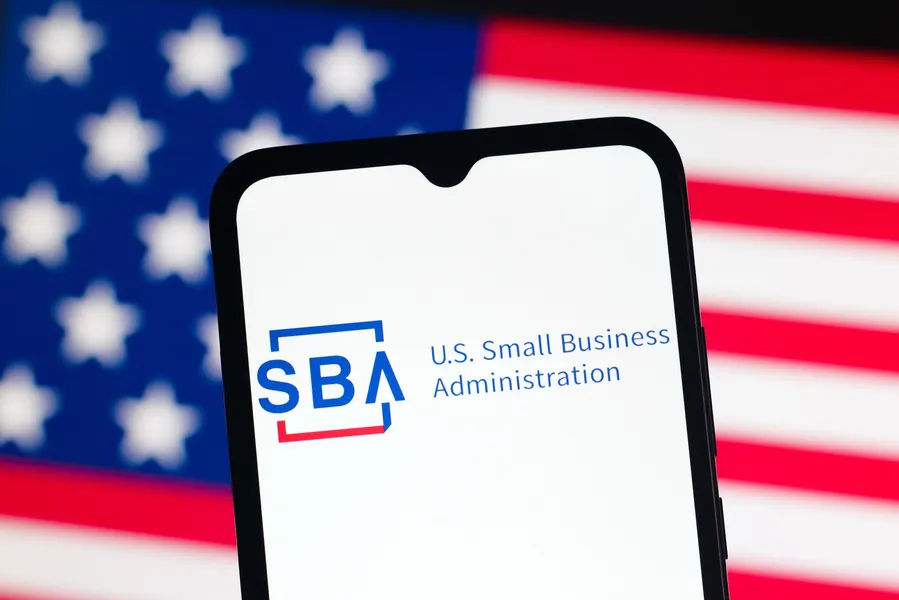 Smartphone displaying the SBA logo and "U.S. Small Business Administration" text against an American flag background.